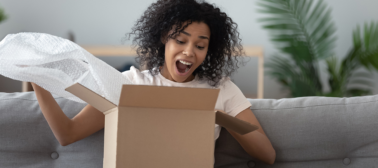 woman opening package in surprise
