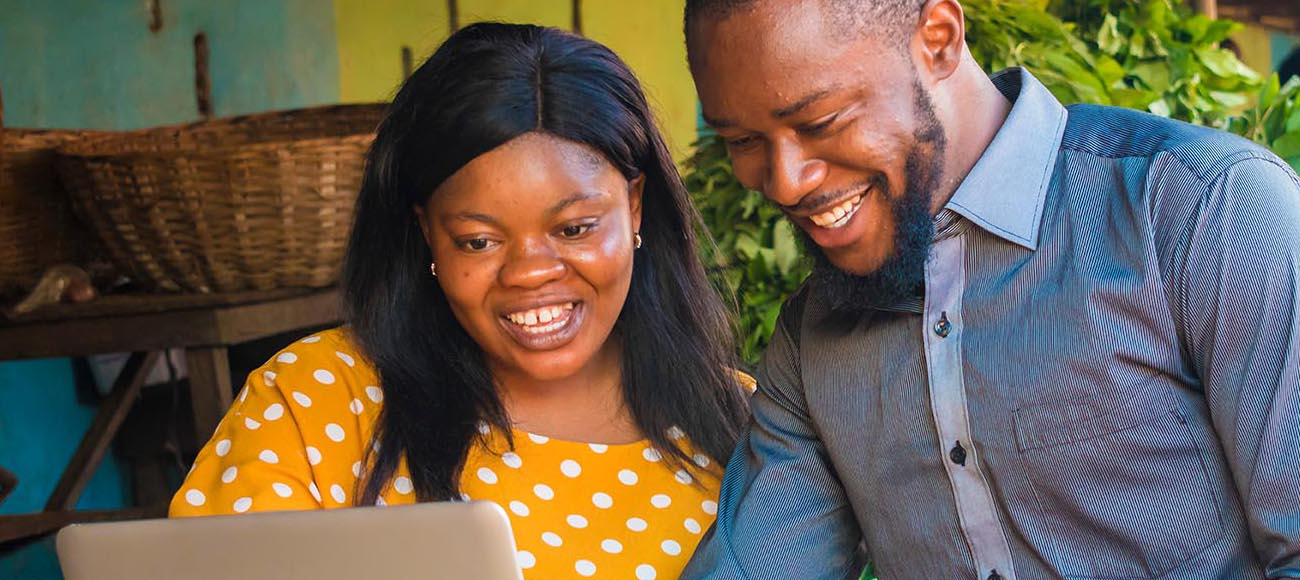 man and woman working on laptop